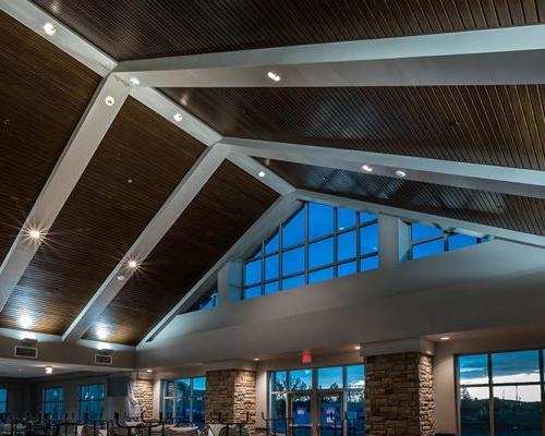 Dining Facility interior featuring dark wood ceiling with white rafters